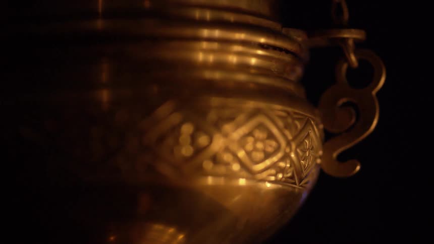Fire reflected on a metal urn