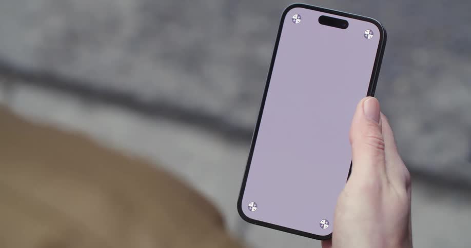A person scrolls on a cell phone with a blank screen