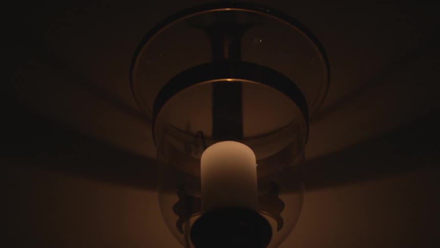 Close-up of a white candle hanging from the ceiling