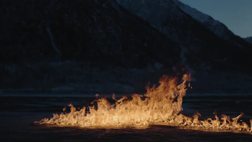 A fire is spreading on a dark field