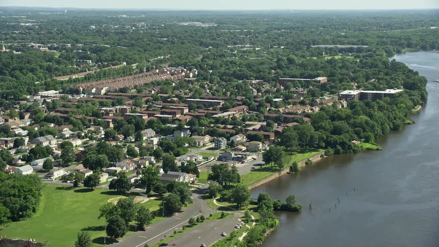 A stunning aerial view of residential homes and apartment buildings situated on waterfront property alongside the Delaware River in Philadelphia Pennsylvania capturing the picturesque beauty of the citys metropolitan areas and riverfront houses