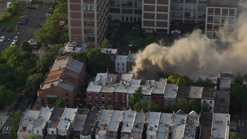 Aerial footage of a smoky residential fire in Downtown Philadelphia during sunset
