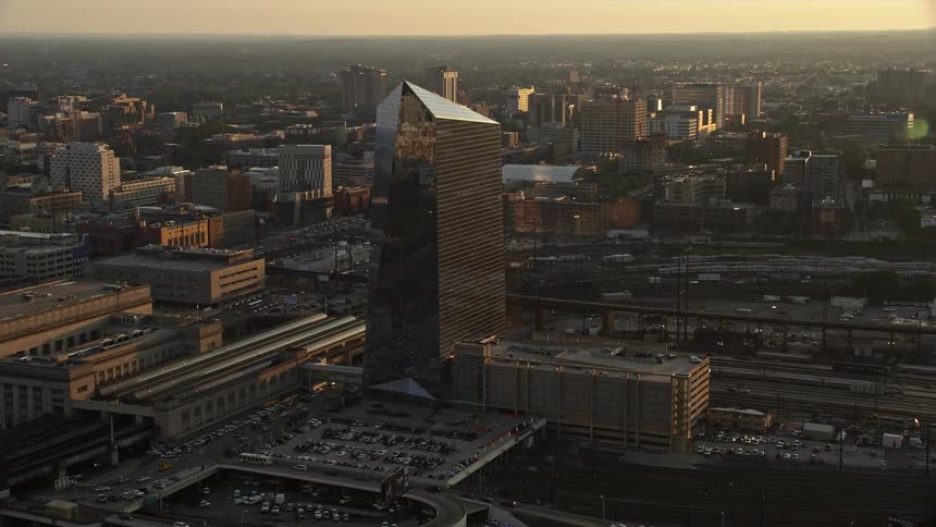 Approaching the modern Cira Centre building in West Philadelphia at sunset shot from an aerial 