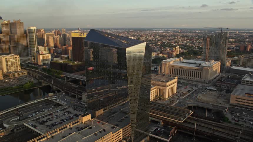 Aerial footage of the Cira Centre office building in West Philadelphia at sunset showcasing the downtown skyline of Pennsylvania