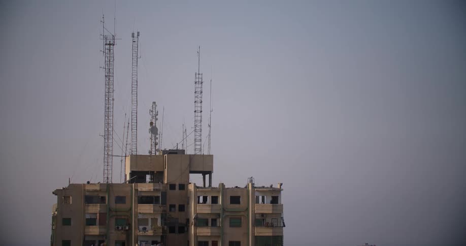 Cranes sit atop an apartment building under construction