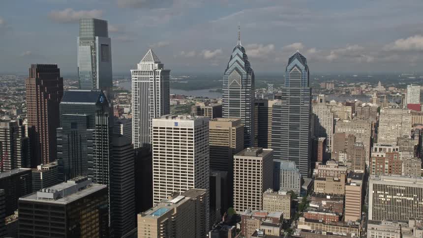 Aerial footage of Philadelphias tallest skyscrapers in the downtown area on a partly cloudy day