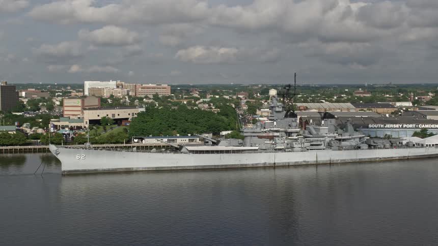 An aerial view of the USS New Jersey battleship docked by the Balzano Marine Terminal in Camden New Jersey on a partly cloudy day