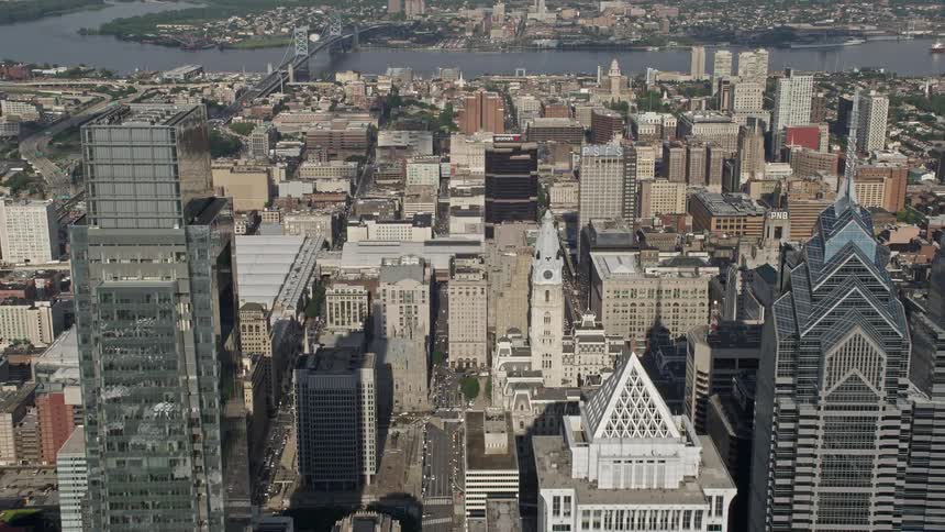An aerial view of Philadelphias skyscrapers and historic landmarks is shown with a flyover toward City Hall and the Pennsylvania Convention Center
