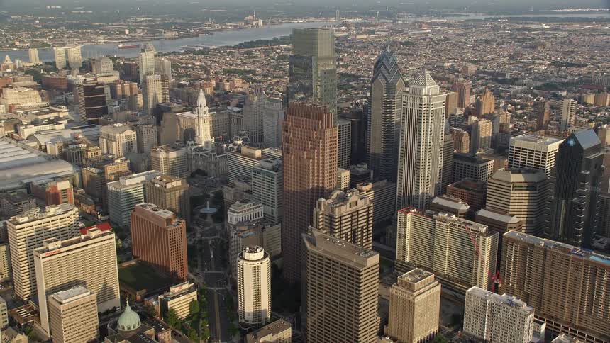 Approaching the iconic Philadelphia City Hall and towering skyscrapers during a gorgeous sunset in the heart of downtown