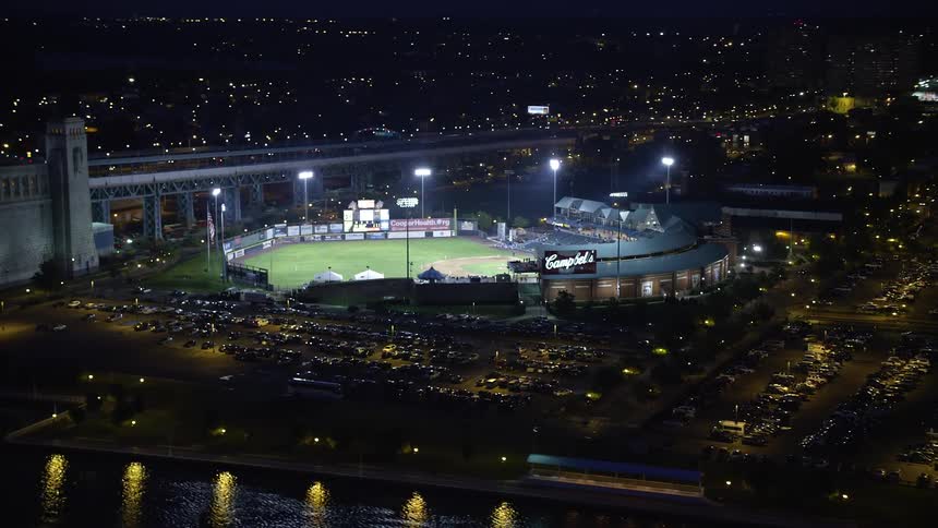Aerial view of a stadium in a downtown city is displayed
