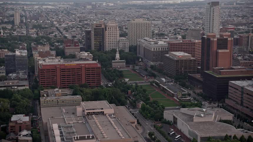 Aerial footage of Independence Hall and Mall Downtown Philadelphia at sunset showcasing its historical and iconic structures as well as its magnificent cityscape