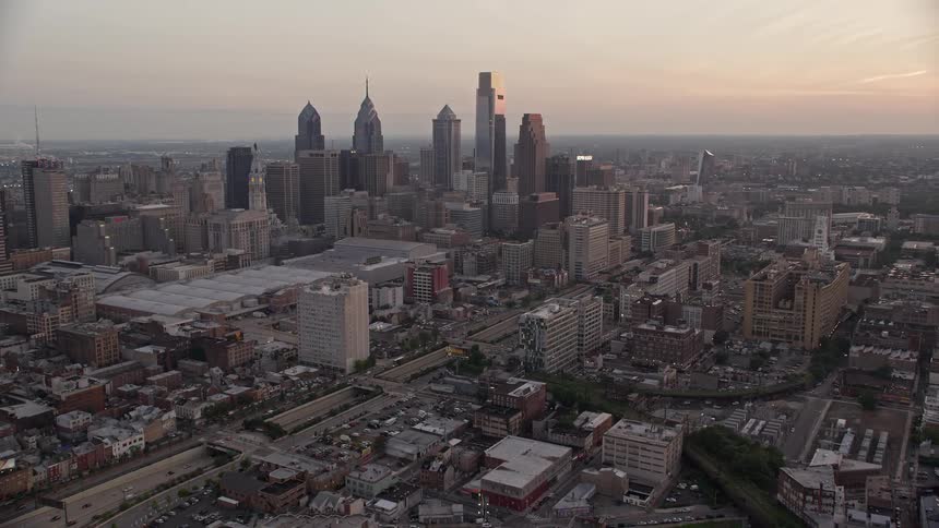 Aerial view of Downtown Philadelphia skyline Pennsylvania Convention Center and I-676 during sunset with light traffic visible on the freeway