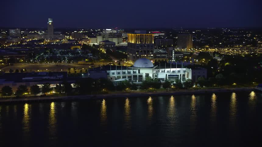 Aerial footage of Adventure Aquarium at night near the Delaware River in Camden New Jersey
