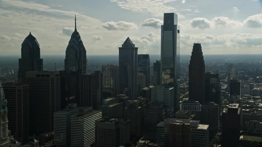 Approaching tall towers in downtown Philadelphia on a partly cloudy day