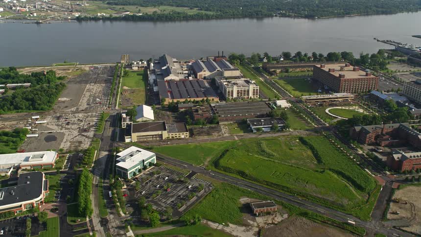Aerial footage of factory buildings at The Navy Yard in Philadelphia Pennsylvania along the Delaware River