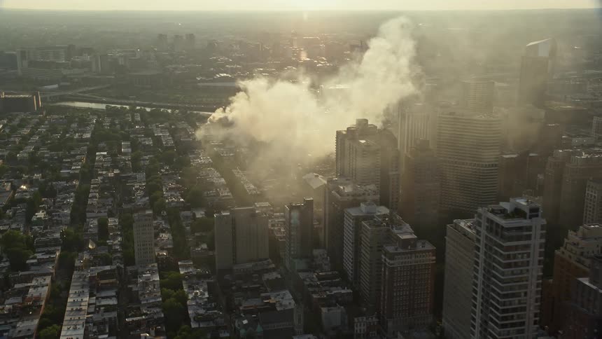 Residential fire during sunset in downtown Philadelphia with office buildings in the background