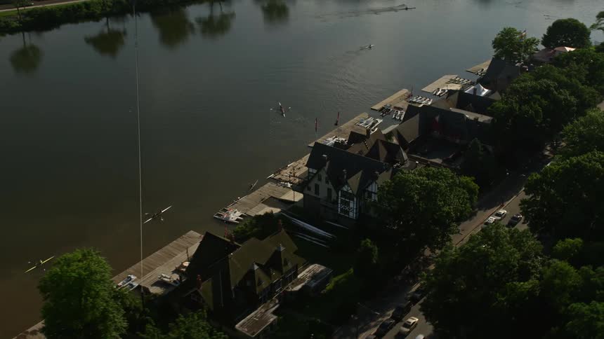 Aerial view of Boathouse Row beside the Schuylkill River showing the historical landmark and recreational activities in the community of Philadelphia Pennsylvania
