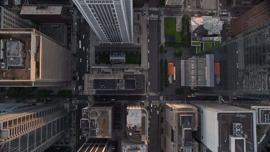 Birds-eye aerial footage captures downtown Philadelphia at sunset with City Hall and JFK Plaza towering over the city streets below