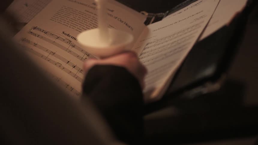 A music sheet is read by candlelight