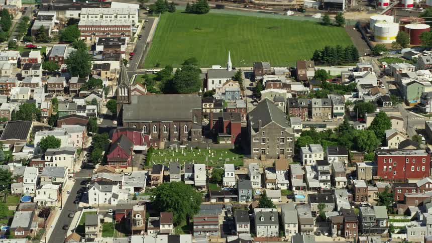 Aerial footage of All Saints Catholic Church and cemetery in North Philadelphia Pennsylvania on a sunny day