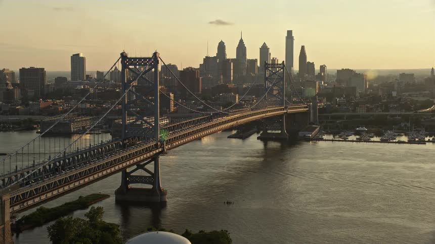 A stunning aerial view of the Benjamin Franklin Bridge and Philadelphias skyline at sunset
