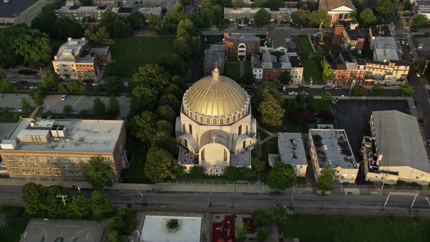 Aerial stock footage approaching and tilting down to Ukrainian Cathedral Church in North Philadelphia Pennsylvania during sunset