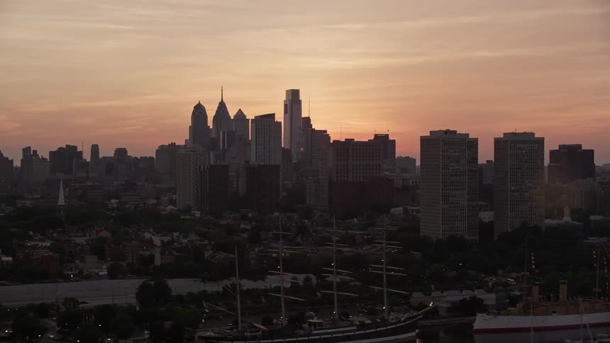 Stunning aerial footage captures Philadelphias breathtaking skyline and inner city as the sunset blankets the metropolis in a warm glow
