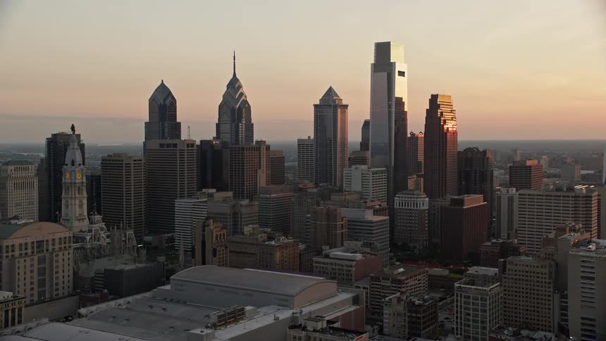 A stunning aerial view of the sun setting amidst the skyscrapers of downtown Philadelphia