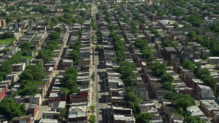An aerial view of row houses in a North Philadelphia urban neighborhood on a sunny day
