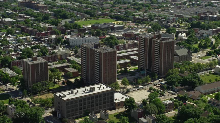 Aerial footage of urban North Philadelphia neighborhood featuring tall residential apartment buildings on a sunny day