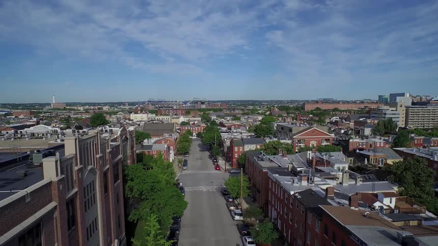 A town has many buildings and cars parked