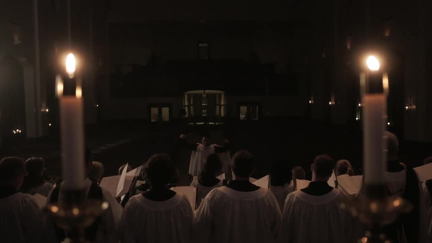 A man directs a choir