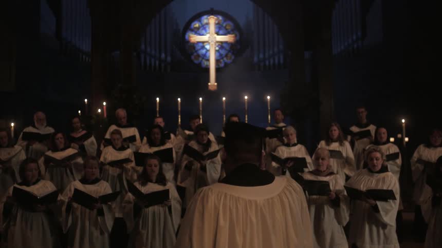 A man directs a church choir