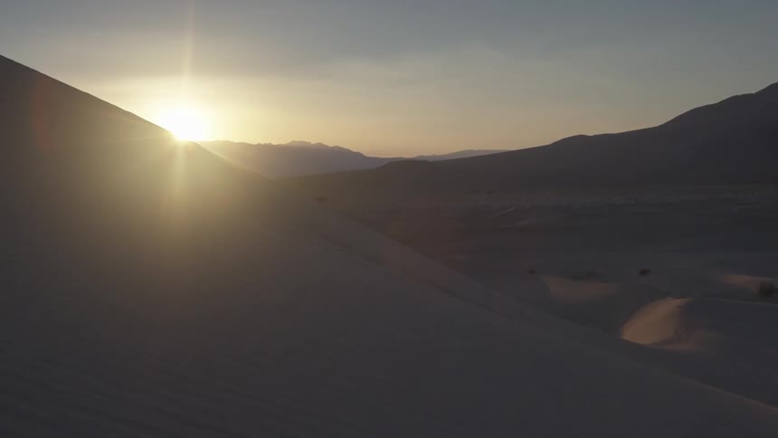 The sun is setting over the hills