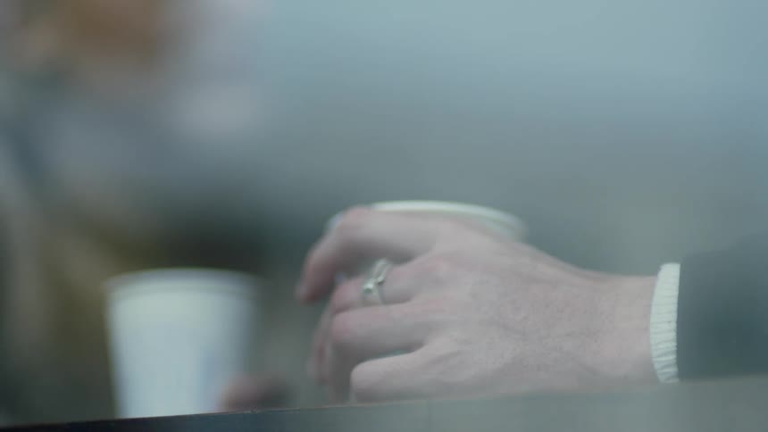 A person drinking from a cup