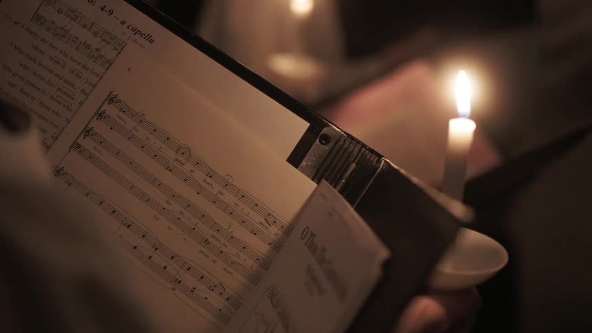 Music sheets are read by candlelight