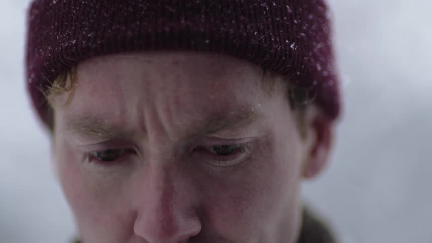 Man standing outside in cold weather looks up and to the side