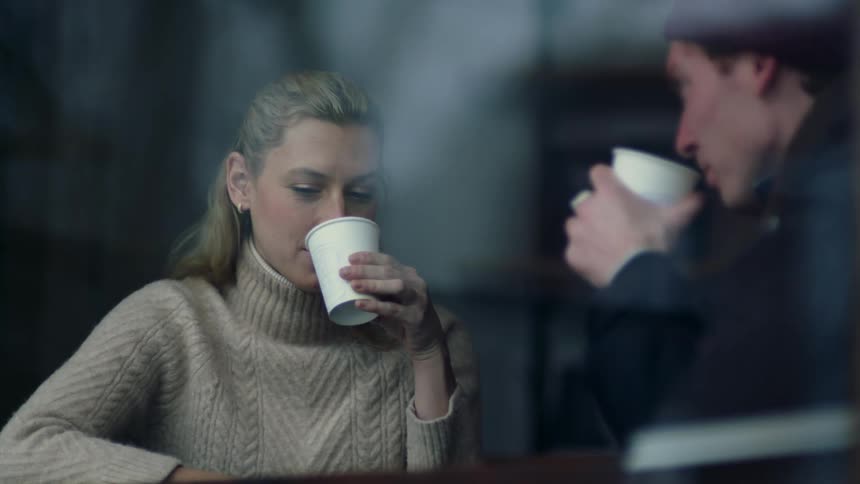 Man and woman are drinking coffee together and talking