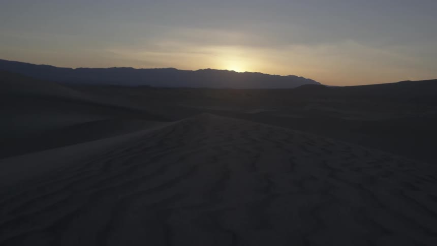 A sandy desert at sunrise