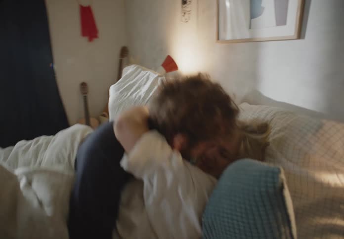 Young couple are in there bed and are kissing