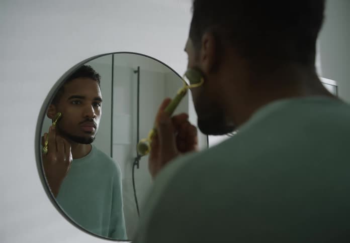 A man is doing his skincare routine