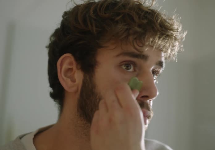 A man is smoothing his skin
