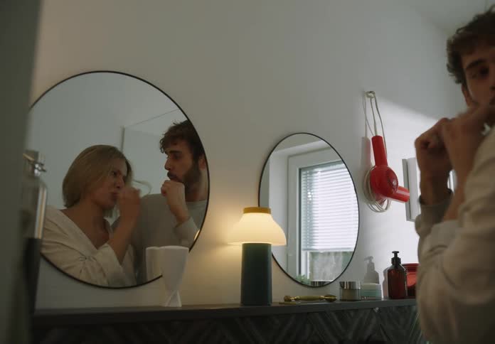 Two people brushing teeth together