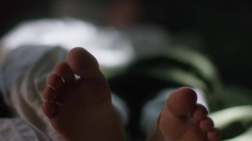 Person lying down shows the soles of their feet and wiggles their toes