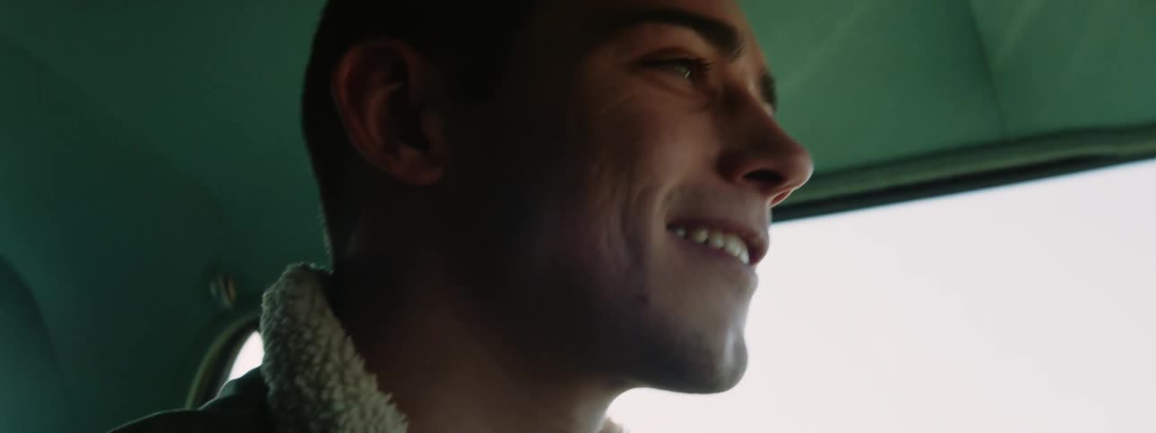 A man driving a car smiling