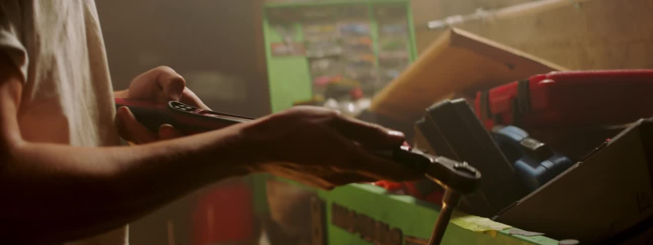 A man attaches a socket to his wrench