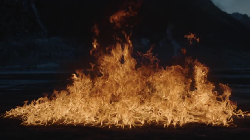 A fire burns outside
