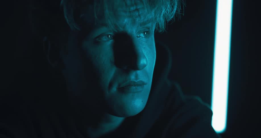 A man looks around the dark room