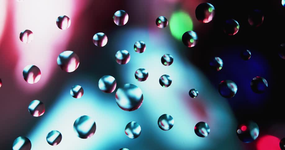 Colored spots rotate under transparent surface with several transparent spots