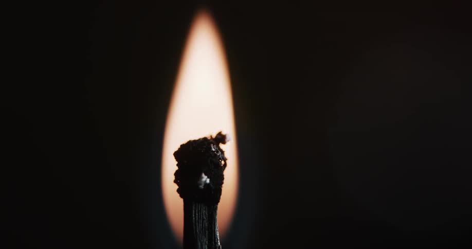 A flame burning on a wick that eventually goes out and smokes